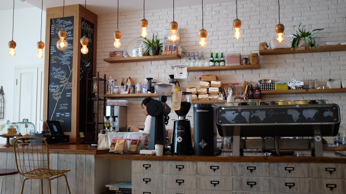 Goldenrod Café — warm interior with exposed brick and handcrafted wooden bar