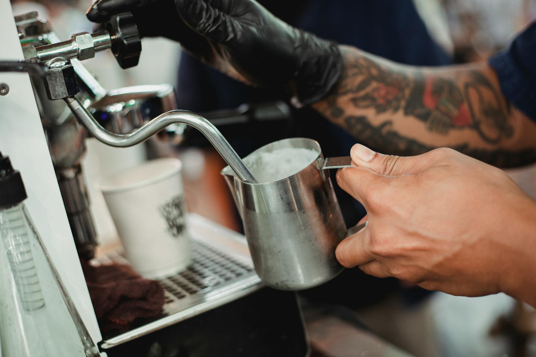 Barista pulling a double espresso shot at the Ember & Bloom bar