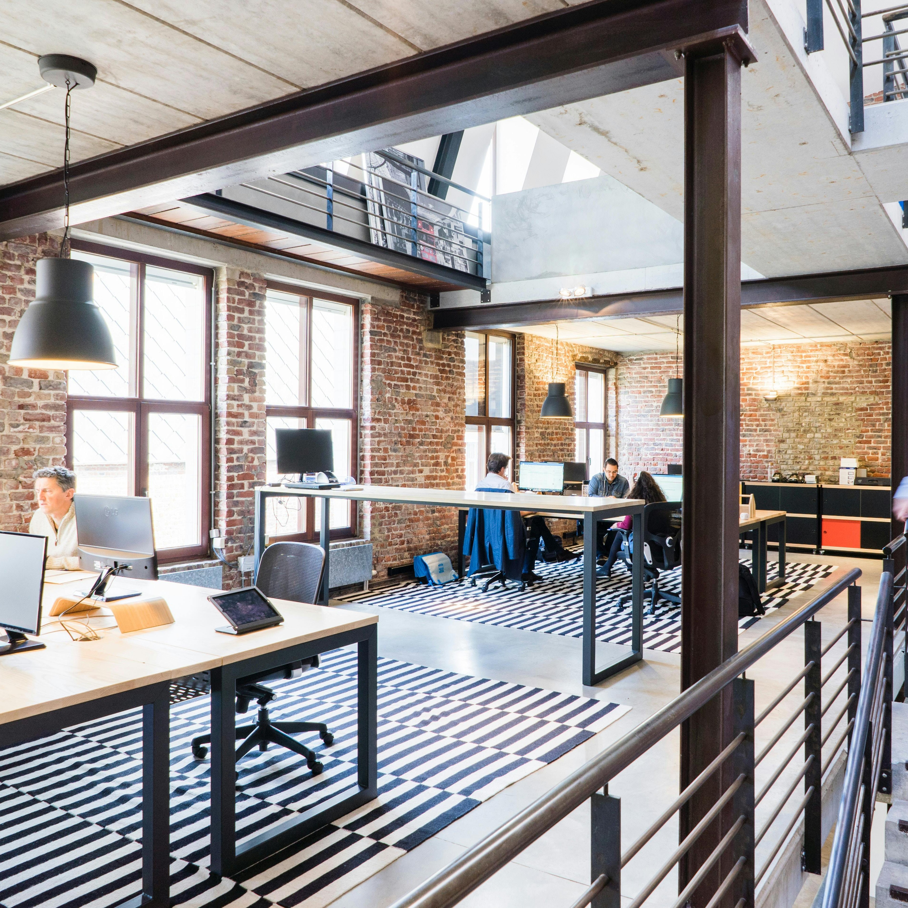 Members collaborating in Summit Workspace's bright open floor