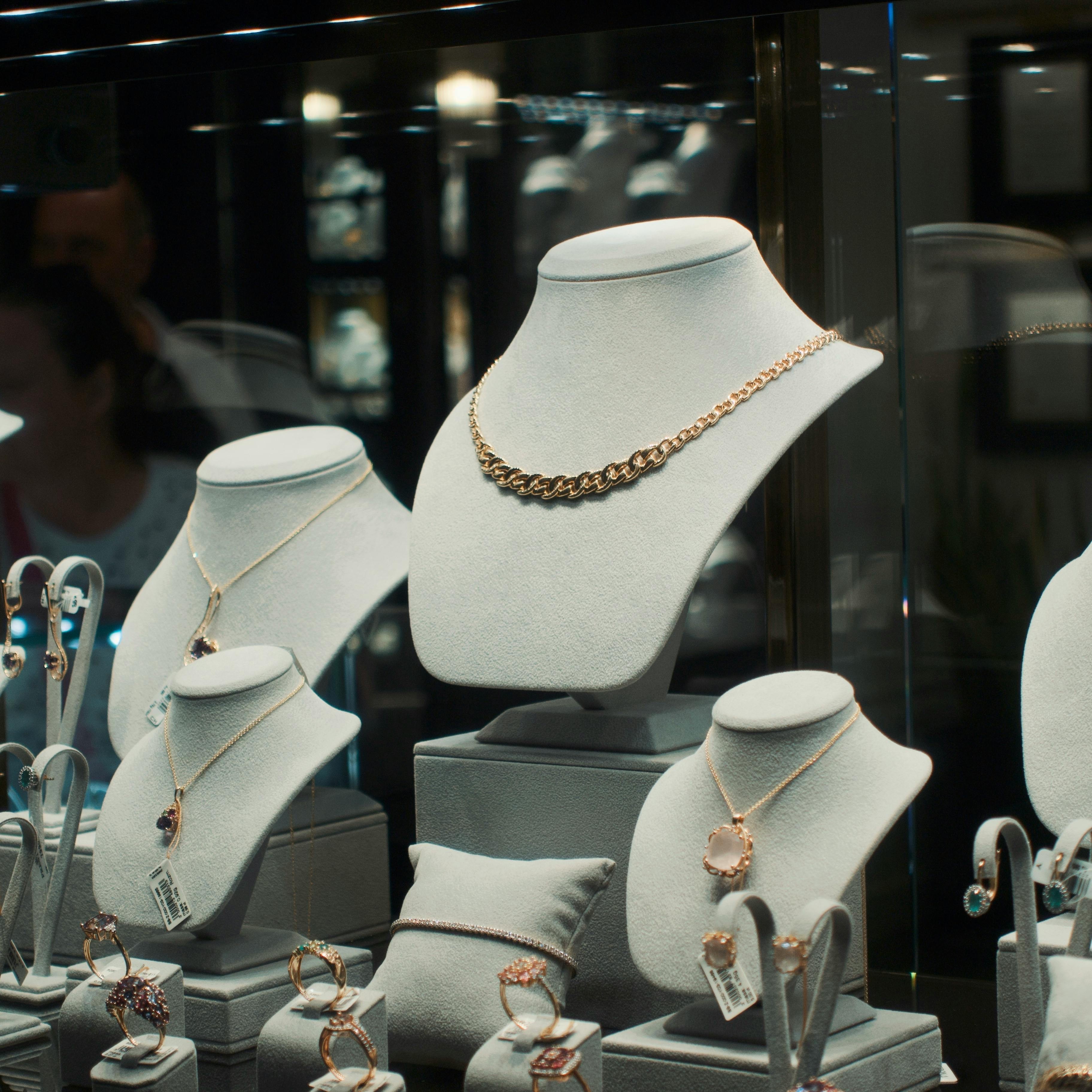 Delicate gold jewelry pieces arranged on stone