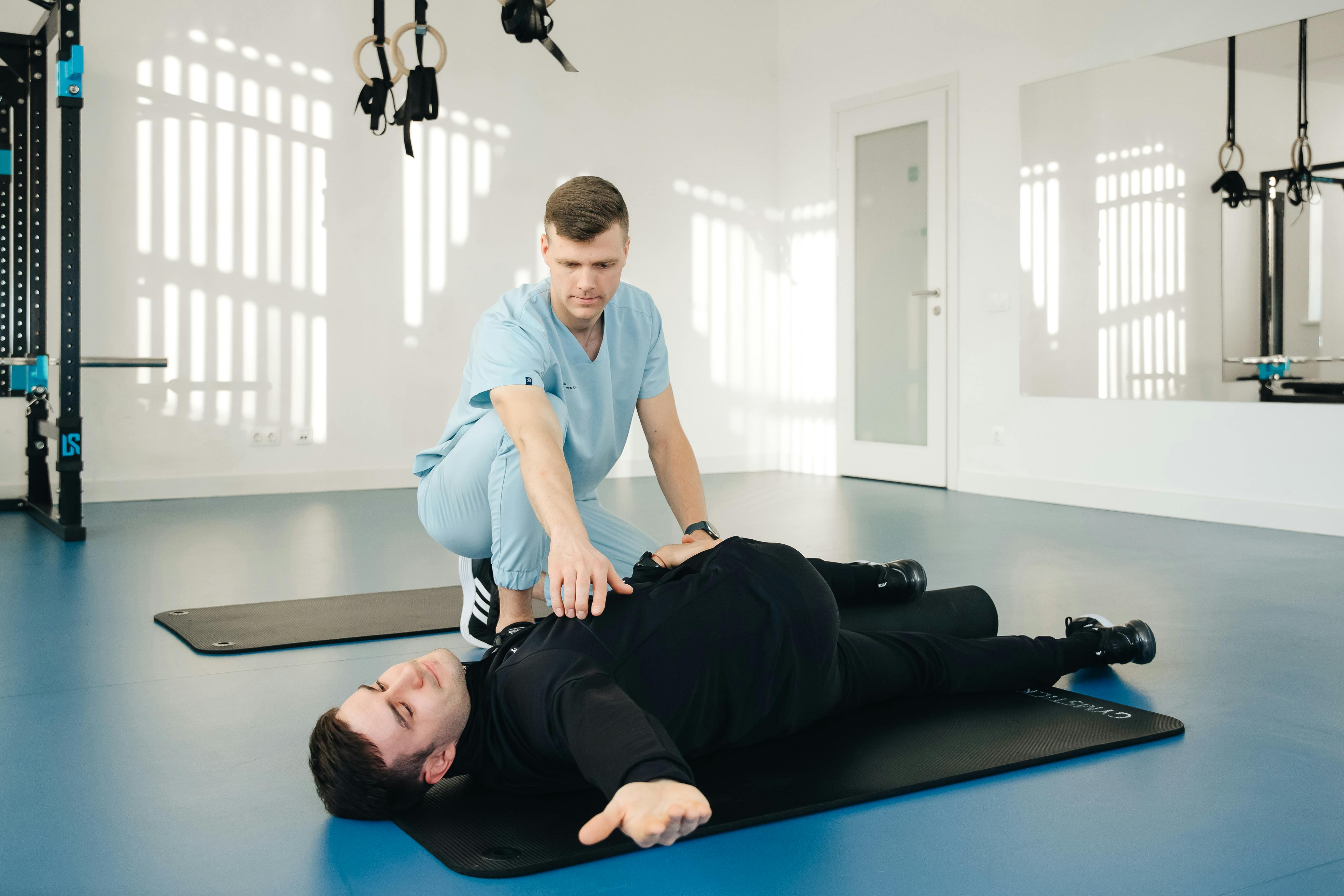 Physical therapist guiding patient through therapeutic exercise